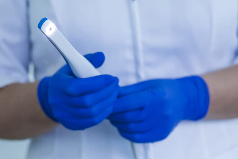 doctor holding an intraoral camera